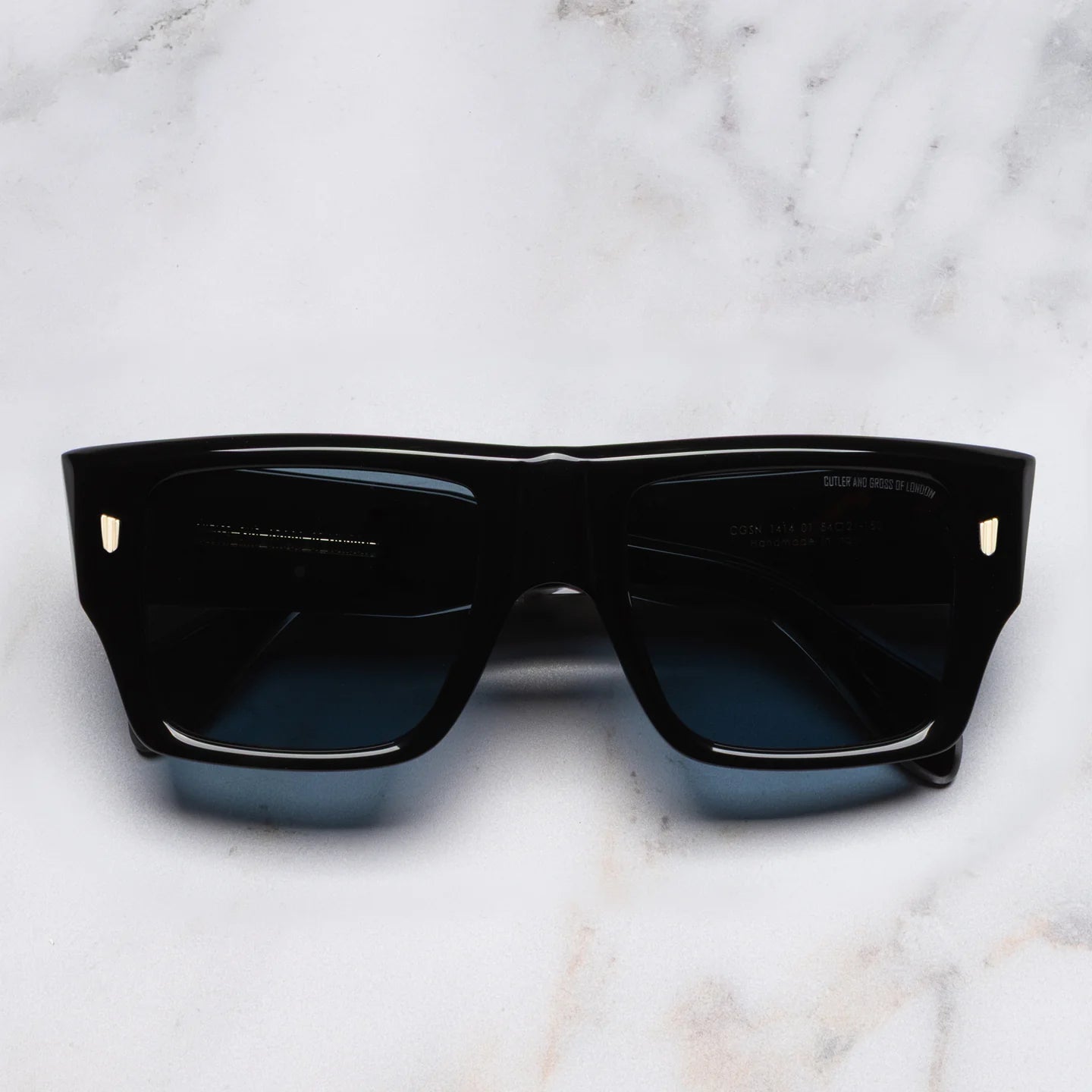 Black sunglasses on a marble surface